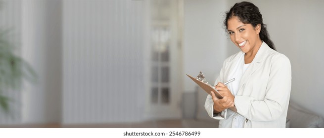 A cheerful healthcare worker stands in a well-lit clinic while holding a clipboard, ready to assist patients with a friendly demeanor and professional appearance. - Powered by Shutterstock