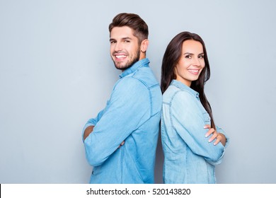 Cheerful Hsppy Man And Woman With Crossed Hands Standing Back To Back.