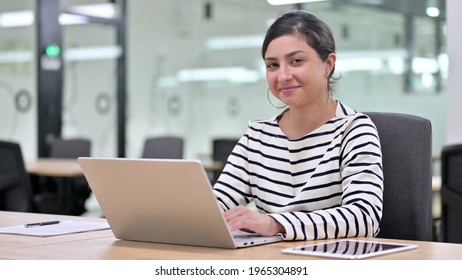 Cheerful Indian Woman With Laptop Saying Yes By Head Shake 