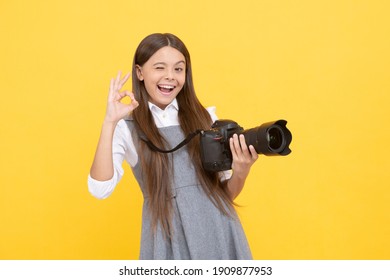 cheerful kid girl take photo with digicam show ok gesture, photography.