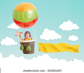 Cheerful Kid On Hot Air Balloon With Banner In The Sky