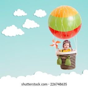 Cheerful Kid On Hot Air Balloon In The Sky