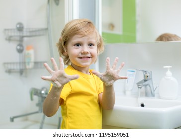 Cheerful Kid Washing Hands And Showing Soapy Palms