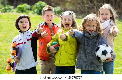 Cheerful Kids With Ball Having Fun Outdoors In Sunny Day