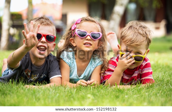 Cheerful Kids Laying On Grass Stock Photo (Edit Now) 152198132