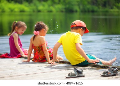 Cheerful kids on the shore of forest lake