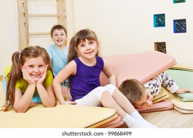 Cheerful Kids Playing With Tumbling Mats