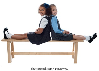 Cheerful Kids Relaxing On School Bench