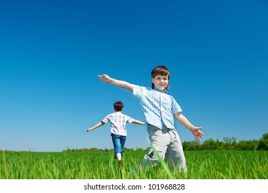 Cheerful Kids Running In The Field