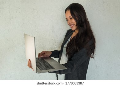 Cheerful Latin Woman Video Chatting On Laptop Computer