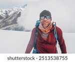 Cheerful laughing climber in sunglasses portrait with backpack ascending Mera peak high slopes at 6000m enjoying legendary Mount Everest, Nuptse, Lhotse with South Face wall beautiful High Himalayas.