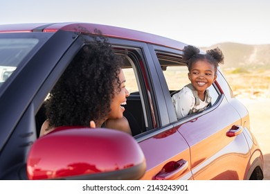 Cheerful little african american daughter sitting on back seat of car looking at mother from mirror while travelling. Young fun woman with cheerful female kid enjoying road trip.  Traveling in car. - Shutterstock ID 2143243901