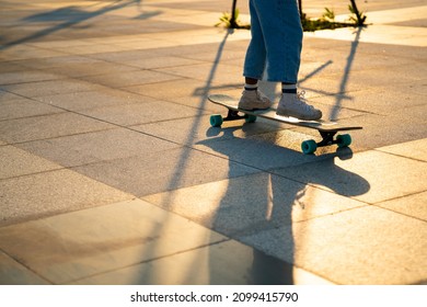 Cheerful Little African Child Girl Kid Skateboarding At Park In The City. Happy Cute Preschool Girl Enjoy And Having Fun Outdoor Lifestyle Practicing Extreme Sport Longboard Skating On Summer Vacation