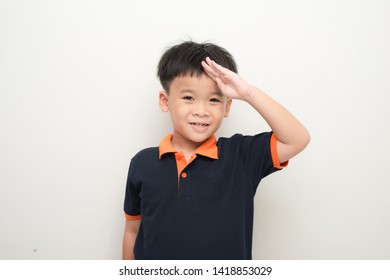 Cheerful Little Boy Putting A Hand On The Forehead Greeting, Isolated On A White Background.