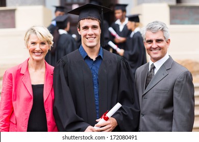 Cheerful Male College Graduate And Parents At Graduation Ceremony