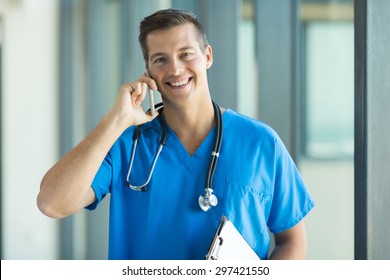 Cheerful Male Doctor Talking On Cell Phone