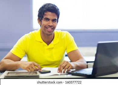 Cheerful Male Indian College Student In Lecture Room