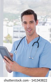 Cheerful Male Nurse Holding A Tablet Pc