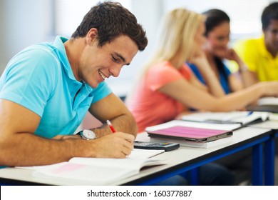 Cheerful Male Uni Student Studying In Lecture Room