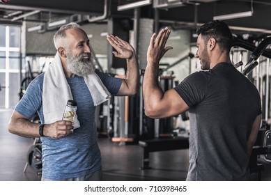 Cheerful males are talking to each other in modern gym - Powered by Shutterstock