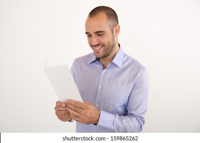 Cheerful Man With Blue Shirt Holding Booklet