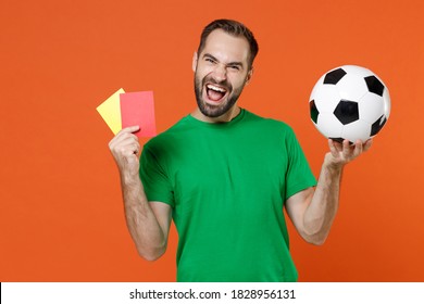 Cheerful man football fan in green t-shirt support favorite team with soccer ball propose player retire from field hold yellow red card isolated on orange background. People sport leisure concept - Powered by Shutterstock