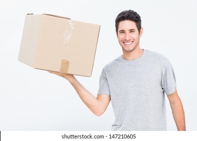 Cheerful Man Holding A Box With One Hand