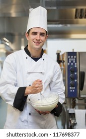 Cheerful Man Mixing Batter In The Kitchen