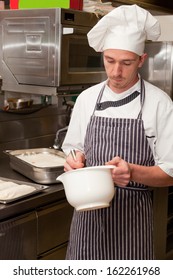 Cheerful Man Mixing Batter In The Kitchen