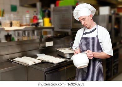 Cheerful Man Mixing Batter In The Kitchen