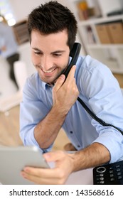 Cheerful Man In Office Answering The Phone