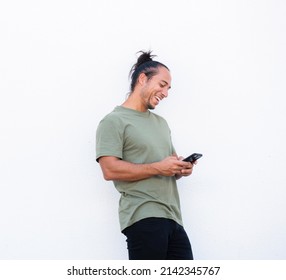 Cheerful Man With Pulled Up Hair Bun Using Mobile Phone Over White Background