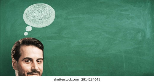 Cheerful man with scribbled thought bubble in chalk-drawn style on green chalkboard background, concept of thinking and brainstorming