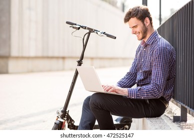 Cheerful man using laptop