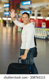 Cheerful Man Waving Goodbye At Airport