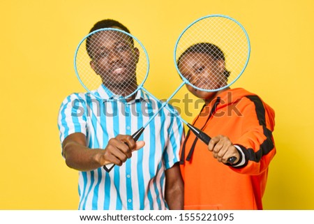 cheerful man and woman of African appearance tennis rackets lifestyle games entertainment