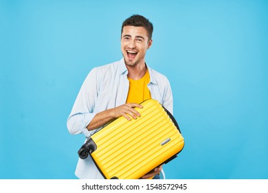 Cheerful man yellow suitcase smile travel flight passport vacation - Shutterstock ID 1548572945