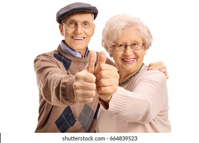 Cheerful mature couple making a thumbs up gesture isolated on white background