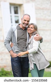 Cheerful Mature Couple Walking In Garden