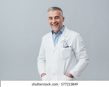 Cheerful mature doctor posing and smiling at camera, healthcare and medicine - Powered by Shutterstock