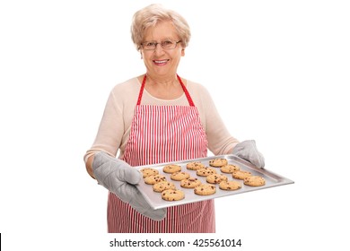 Cheerful Mature Lady Holding A Tray Full Of Homemade Chocolate Chip Cookies Isolated On White Background