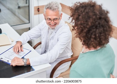 Cheerful Mature Rehabilitation Physiotherapy Doctor Telling His Prescriptions