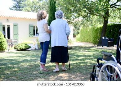 Cheerful Mature Woman Visiting Her Mother Elderly Senior Female Walk In Retirement House Hospital Garden