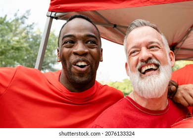 Cheerful Men Hugging At A Tailgate Party