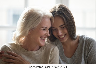 Cheerful Middle Aged Mother Grown Up Adult Daughter Laughing Enjoy Spend Time Together Embracing Having Fun, Two Different Generation Relative People, Love Warm Relationships And Affectionate Concept