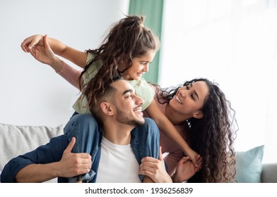 Cheerful Middle Eastern Family Of Three Having Fun Together At Home - Shutterstock ID 1936256839
