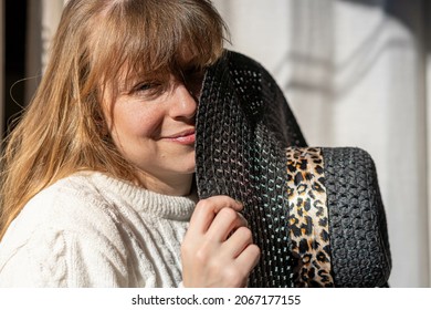 A Cheerful Middle-aged Argentine Lady Holding A Sun Ha In The Sun