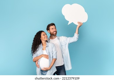 Cheerful Millennial Caucasian Man With Beard Hug Pregnant Arab Woman With Belly, Look At Abstract Cloud Buble With Blank Space, Isolated On Blue Background. Relationship And Love, Expecting Baby, Ad