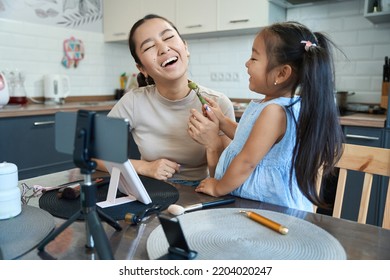 Cheerful Mom Blogger And Daughter Have Fun Together In Front Camera