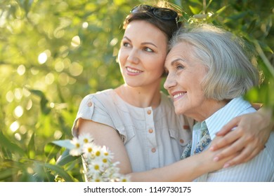 cheerful mother and adult daughter